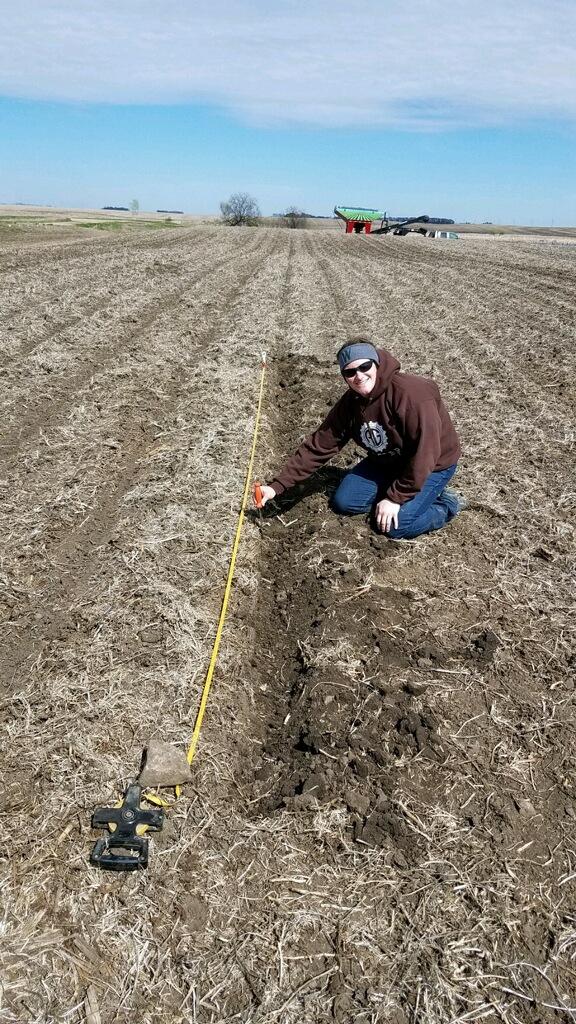 Lindsay Overmyer measuring a field