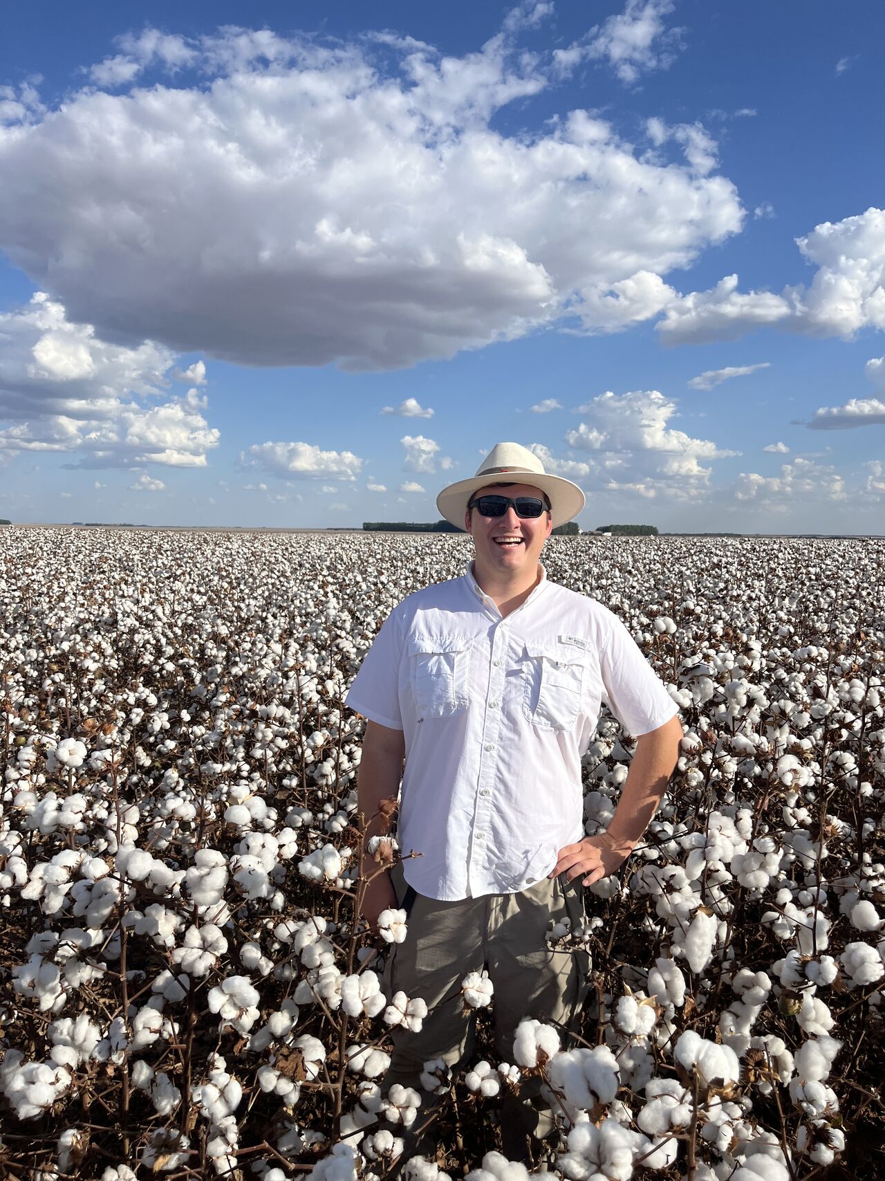 Alex Angel standing in a cotton field